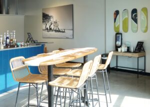 Photo provided by Moonrise Coffee Roasters, image of surfboard shaped table with chairs inside of coffee shop.